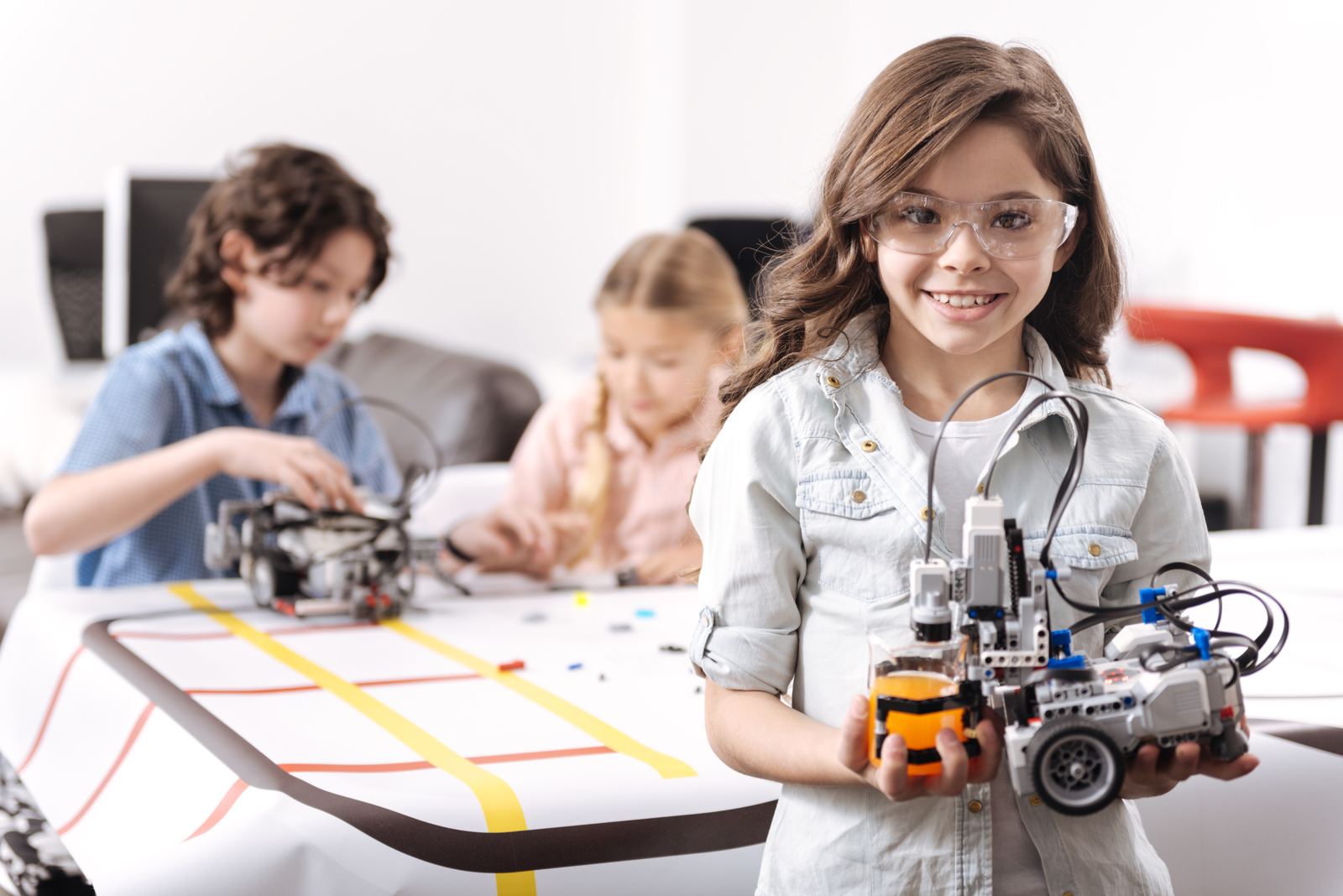 Student proudly holding her robot